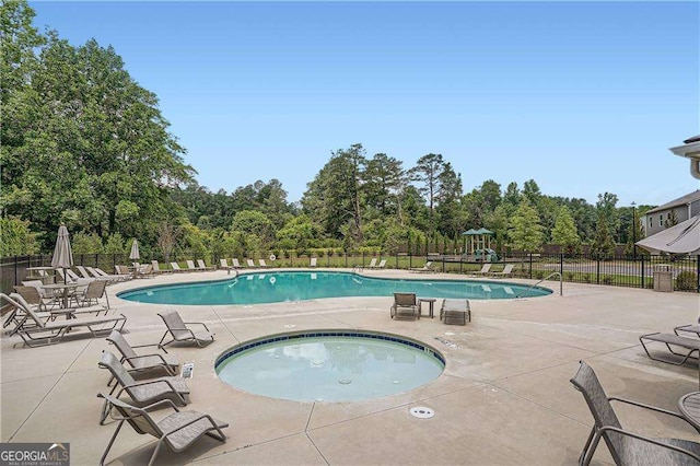 view of swimming pool with a community hot tub and a patio