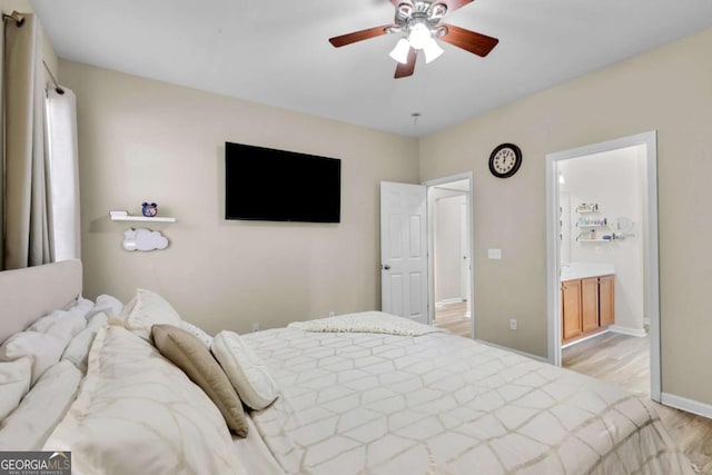 bedroom with ceiling fan, light hardwood / wood-style floors, and ensuite bathroom