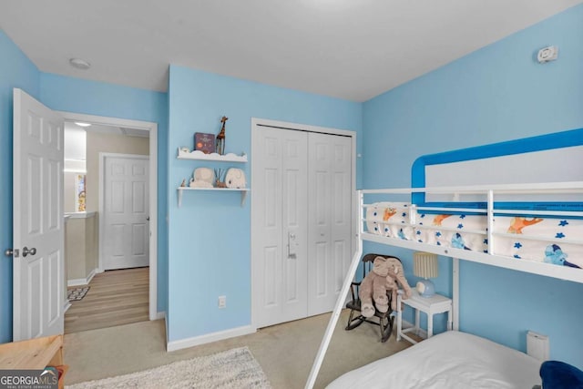 bedroom featuring a closet and light colored carpet