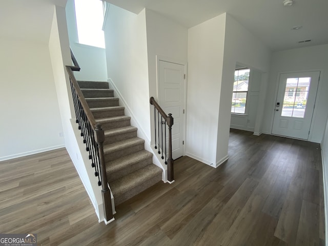 entryway with dark hardwood / wood-style flooring