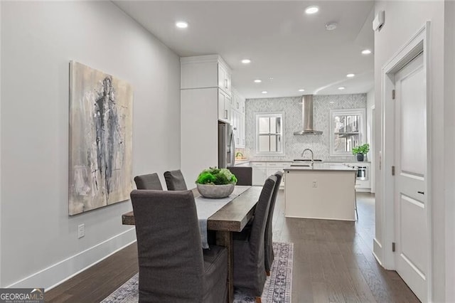 dining area with sink and dark wood-type flooring