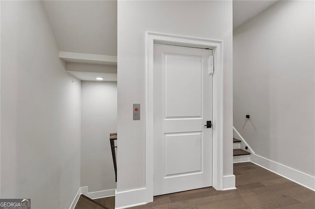 corridor featuring dark hardwood / wood-style floors