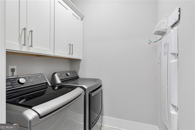 laundry area featuring cabinets and separate washer and dryer