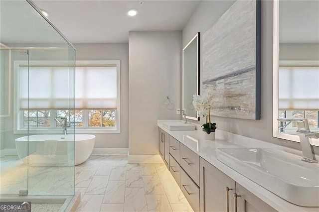 bathroom featuring vanity, separate shower and tub, and a healthy amount of sunlight