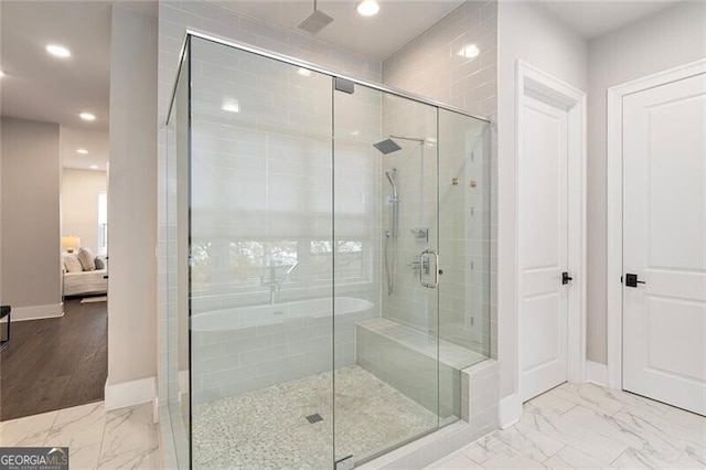 bathroom with hardwood / wood-style floors and walk in shower