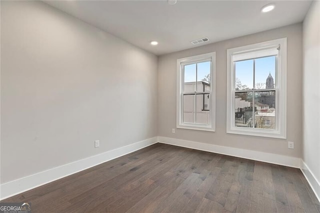 empty room featuring dark hardwood / wood-style flooring