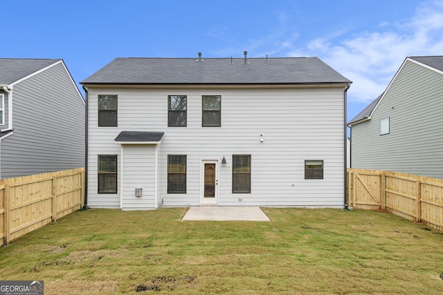 rear view of house featuring a lawn and a patio area