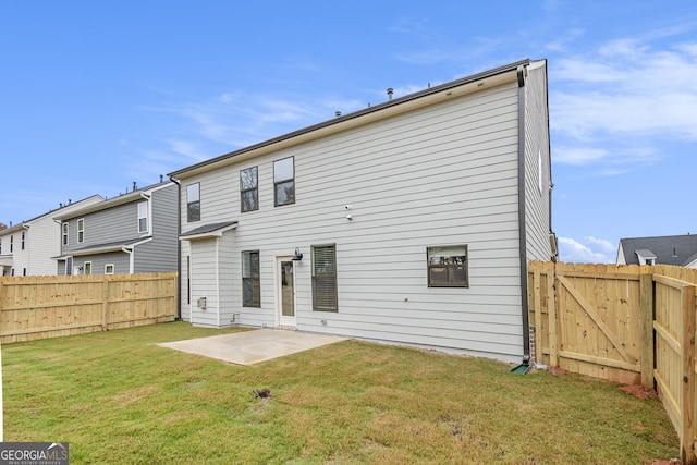 back of property with a lawn and a patio