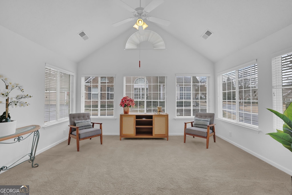 sunroom with ceiling fan and vaulted ceiling