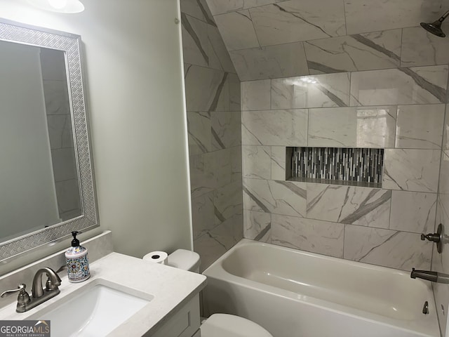 full bathroom featuring vanity, tiled shower / bath combo, and toilet