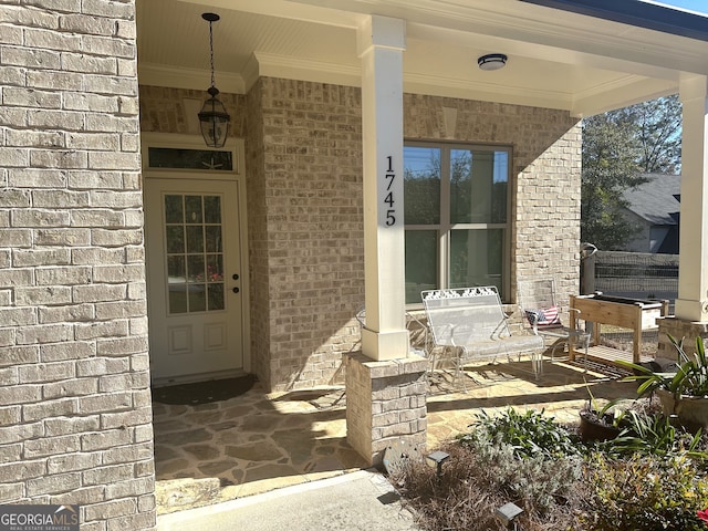 view of exterior entry with a porch