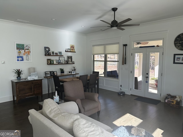 living room with a wealth of natural light, dark hardwood / wood-style flooring, and crown molding