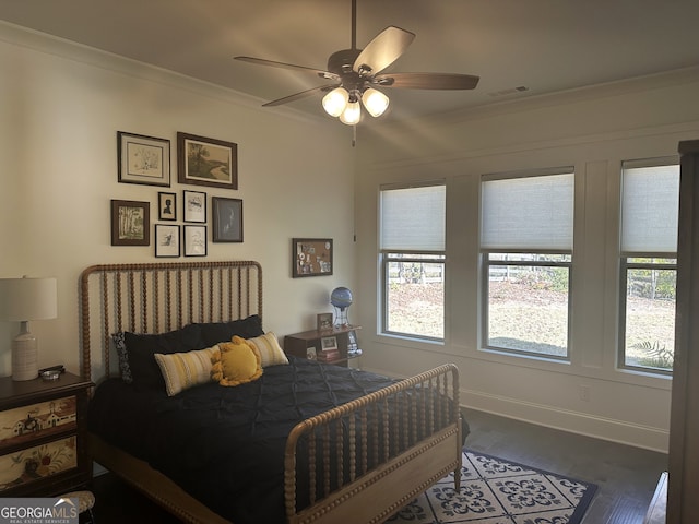 bedroom with hardwood / wood-style floors, ceiling fan, and ornamental molding