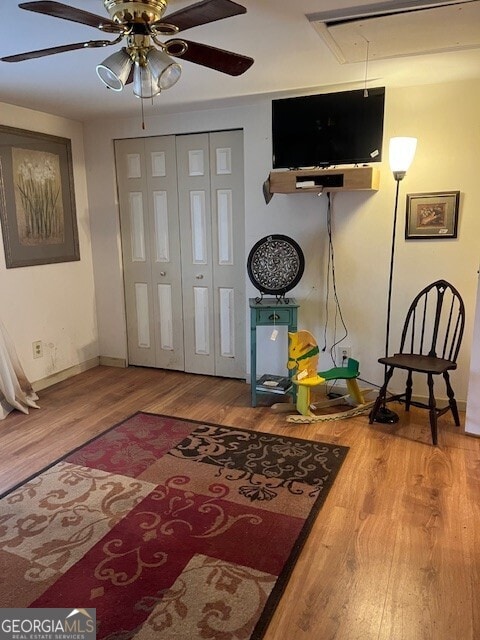 entryway with baseboards, wood finished floors, and a ceiling fan