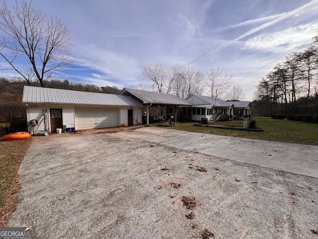 ranch-style home with a garage and a front lawn