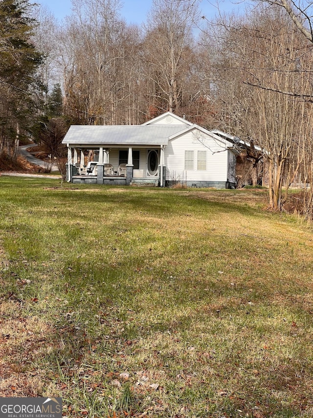 ranch-style home with covered porch and a front yard