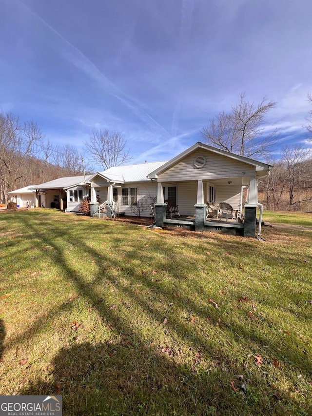 view of front of house with a porch and a front yard