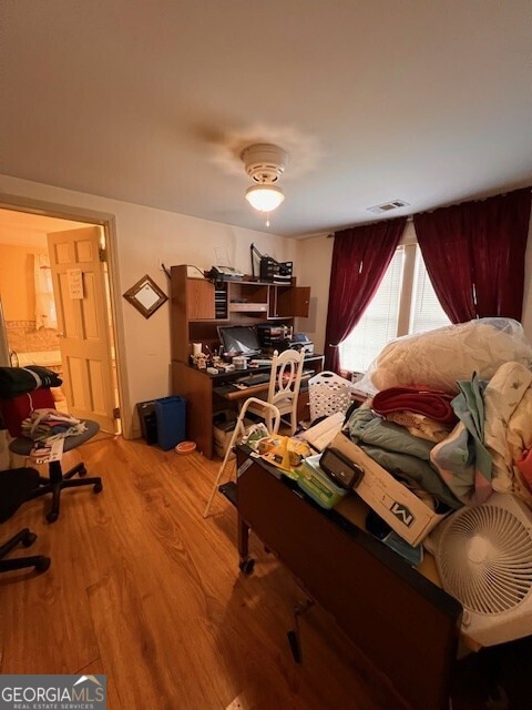 bedroom with visible vents and wood finished floors