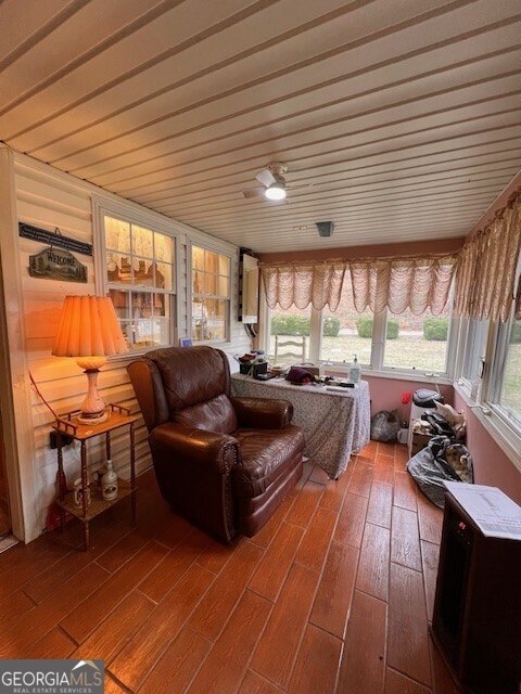 sunroom / solarium with a ceiling fan