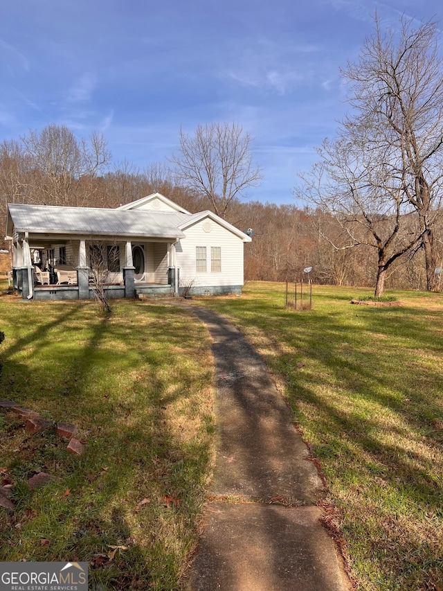 bungalow-style home featuring metal roof, a porch, and a front lawn