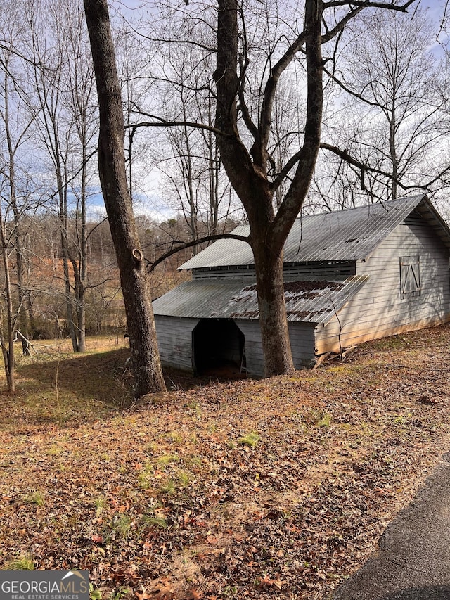 view of property exterior featuring metal roof