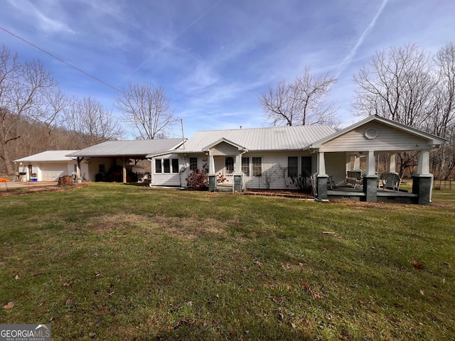 rear view of property with a lawn and metal roof