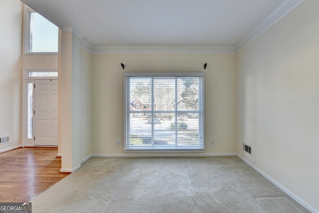 carpeted spare room with ornamental molding