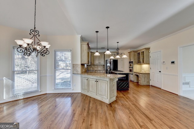 kitchen with light stone countertops, tasteful backsplash, stainless steel fridge with ice dispenser, kitchen peninsula, and pendant lighting