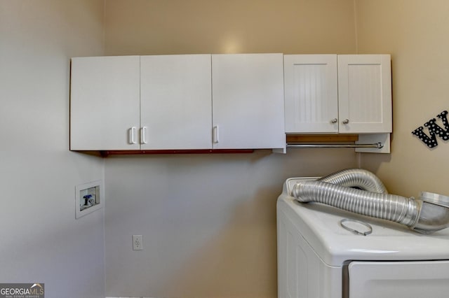 laundry room featuring cabinets and washer / clothes dryer