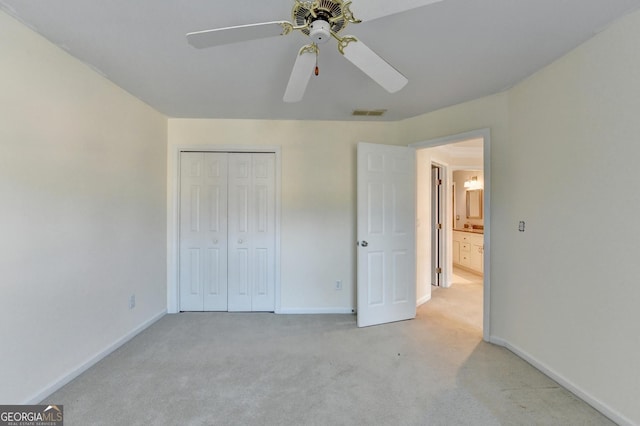 unfurnished bedroom featuring ceiling fan, light carpet, and a closet