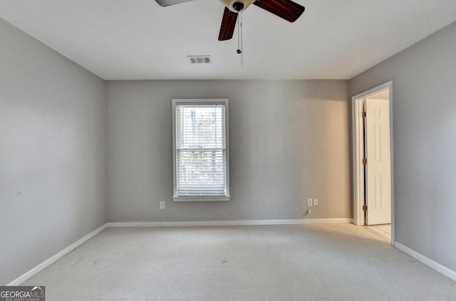 carpeted spare room featuring ceiling fan