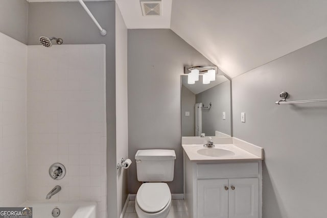 full bathroom with vanity, tiled shower / bath combo, vaulted ceiling, tile patterned flooring, and toilet