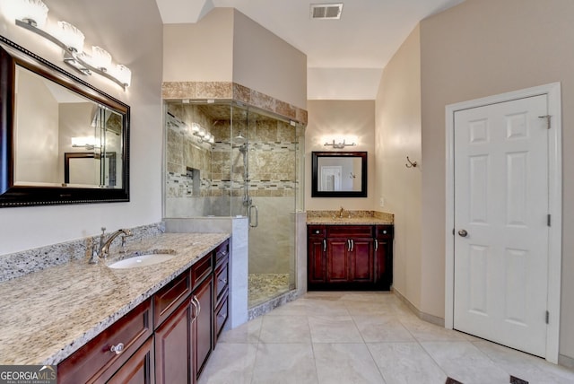 bathroom with vanity, tile patterned floors, and walk in shower