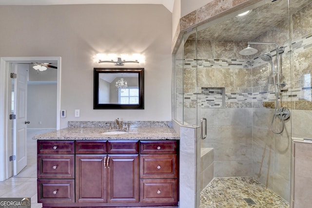 bathroom with ceiling fan, a shower with door, vanity, and tile patterned flooring