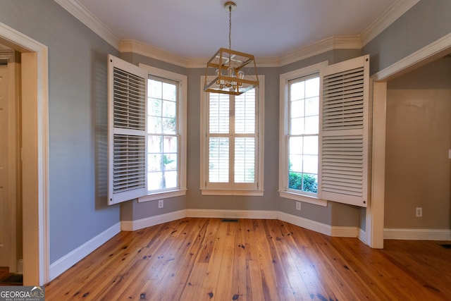 unfurnished dining area with ornamental molding, light wood-type flooring, and a healthy amount of sunlight