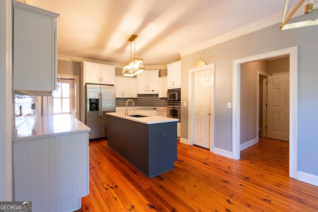 kitchen with decorative light fixtures, stainless steel appliances, dark hardwood / wood-style floors, and an island with sink