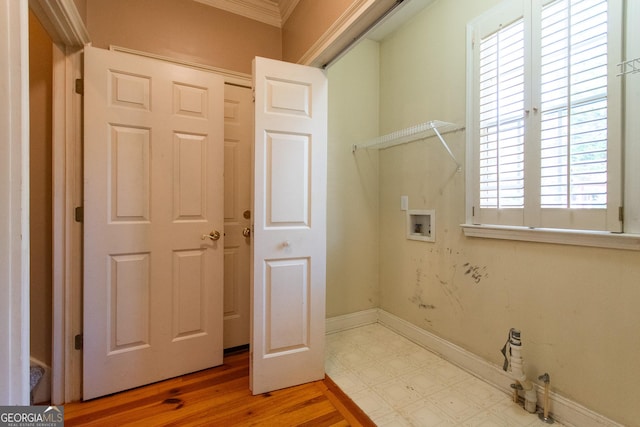 clothes washing area featuring hardwood / wood-style floors, plenty of natural light, crown molding, and hookup for a washing machine