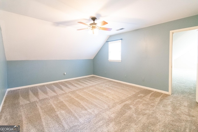 additional living space with ceiling fan, carpet floors, and lofted ceiling