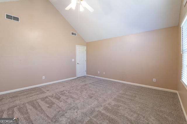 spare room with carpet floors, ceiling fan, and high vaulted ceiling