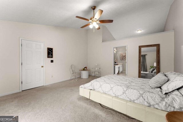 carpeted bedroom featuring ensuite bathroom, ceiling fan, and vaulted ceiling