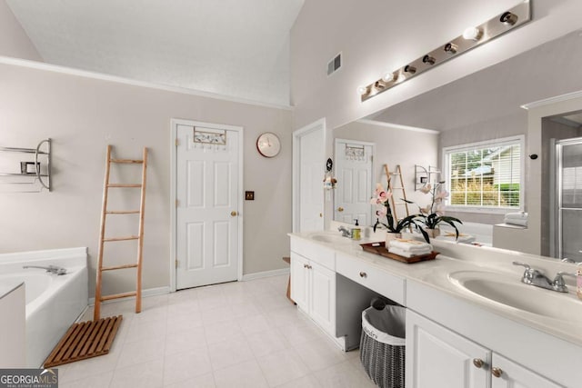 bathroom with vanity, a tub, and vaulted ceiling