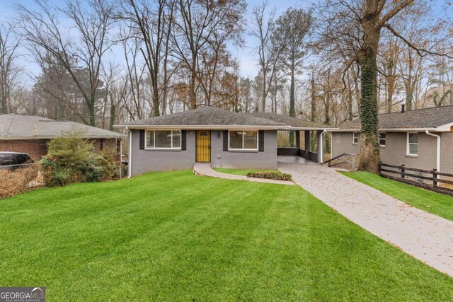 single story home with a front yard and a carport