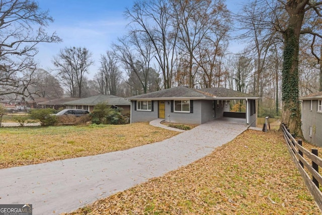 ranch-style home with a front yard and a carport