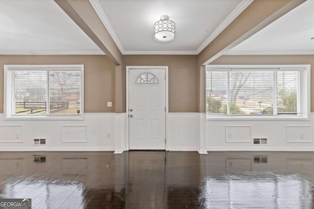 entryway featuring a wealth of natural light and ornamental molding