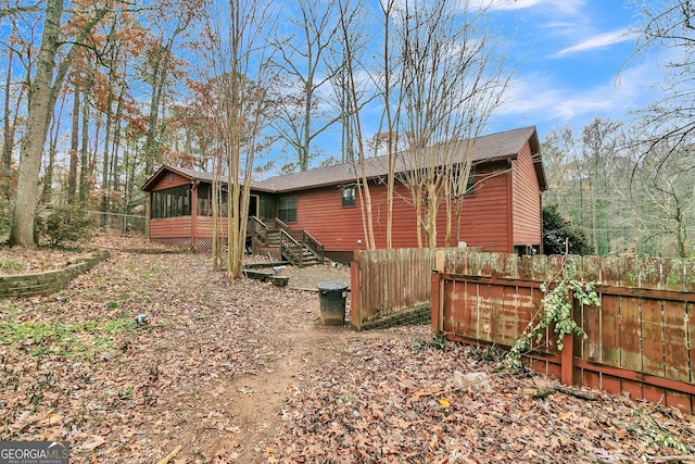 back of property featuring a sunroom