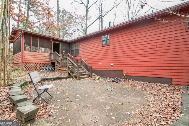 rear view of property with a sunroom