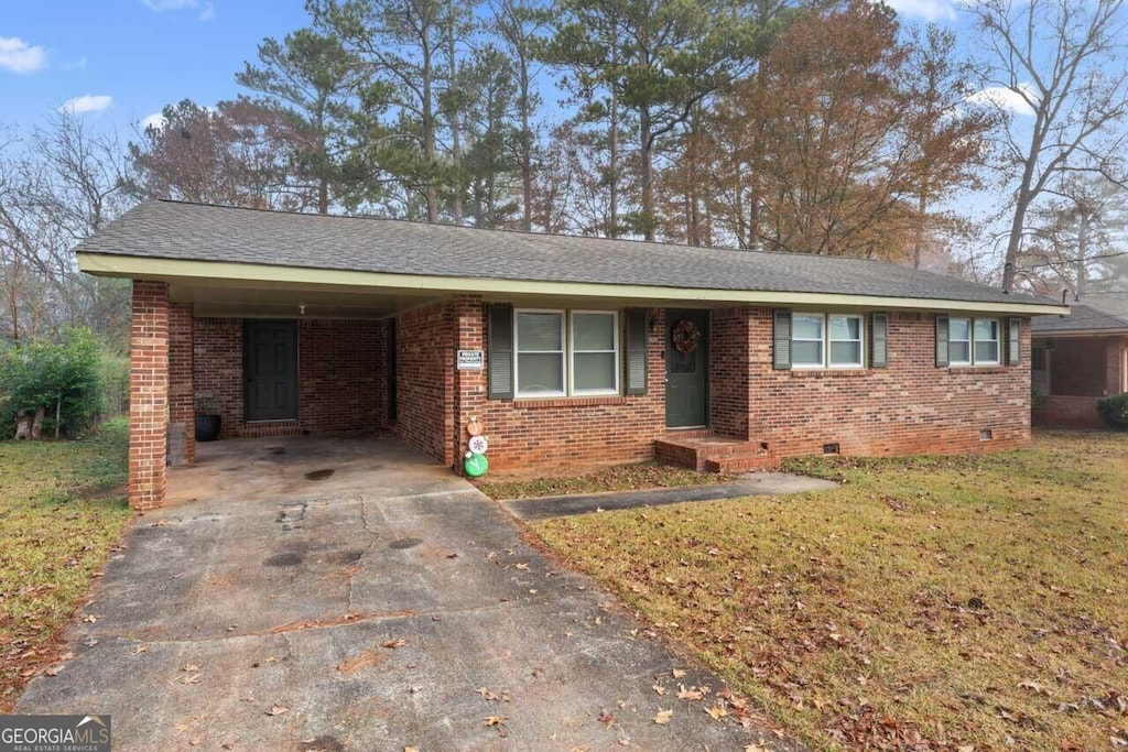 ranch-style house with a front yard and a carport