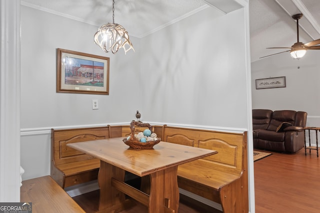 dining space with light hardwood / wood-style flooring, breakfast area, a textured ceiling, ceiling fan with notable chandelier, and ornamental molding