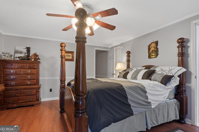 bedroom with hardwood / wood-style floors, ceiling fan, ornamental molding, and a textured ceiling