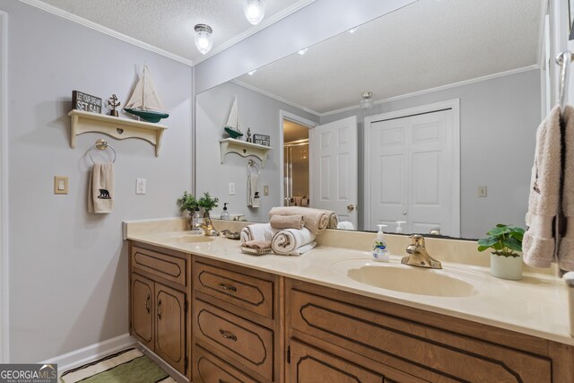 bathroom featuring crown molding, vanity, a textured ceiling, and walk in shower